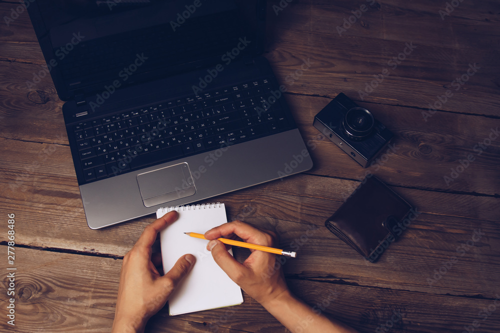 Fototapete workplace blogger. set to prepare for public speaking and writing text: keyboard and phone on a wooden table, top view. freelancer writes the text in a notebook