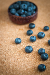 Freshly picked blueberries in woven natural screwpine leaf bowl. Juicy and fresh blueberries with on rustic table. Bilberry on wooden Background. Blueberry antioxidant. Concept for healthy eating.