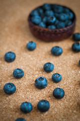 Freshly picked blueberries in woven natural screwpine leaf bowl. Juicy and fresh blueberries with on rustic table. Bilberry on wooden Background. Blueberry antioxidant. Concept for healthy eating.