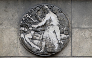 Incantation. Stone relief at the building of the Faculte de Medicine Paris, France
