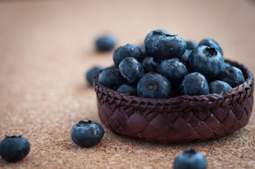 Freshly picked blueberries in woven natural screwpine leaf bowl. Juicy and fresh blueberries with on rustic table. Bilberry on wooden Background. Blueberry antioxidant. Concept for healthy eating.