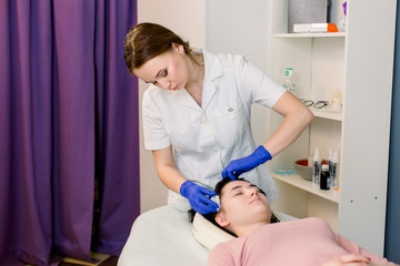 Procedure of mesotherapy. The doctor cosmetologist makes the beauty procedure in woman's head....