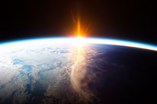 Earth planet and sunrise view from space - element of this image provided by Nasa