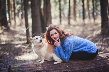Naklejka na ściany i meble Beautiful woman playing with her dog. Outdoor portrait.