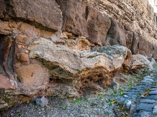 Ancient stonework at the base of the fortress wall in Tivoli, Italy