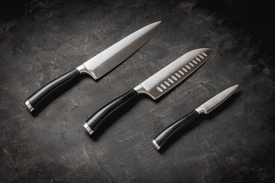 Modern Kitchen Knives Set on Stone Background. Chef's Knives Concept.