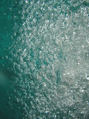 Small air bubbles in the water. Underwater background. Aquamarine bubbles. Water splash. Turquoise bubbles. Aquamarine water.  Turquoise water. 