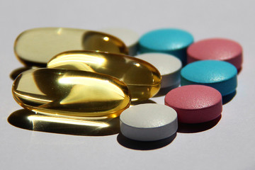 Colorful different capsules and pills on light background. Close up of pills capsules. Medicine and pharmacy concept...