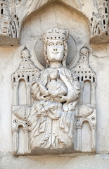 Fototapeta na wymiar Enthroned Madonna, portal of Santa Maria Forisportam church in Lucca, Tuscany, Italy 