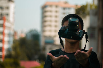 Portrait of young boy,covering his face with the camera