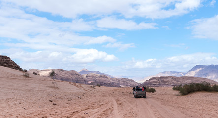 Tourists ride in open jeeps in the Wadi Rum desert near Aqaba city in Jordan