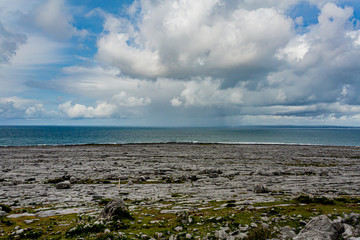 Irish landscape of the sea and rocky limestone coast between Bothar nA hAillite and Fanore, geosite and geopark, Wild Atlantic Way, spring day in county Clare in Ireland