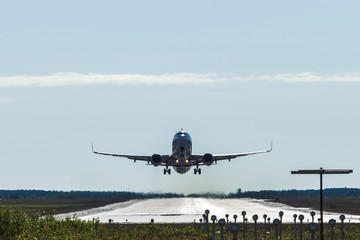 Big passenger airplane taking off and flying from an airport.