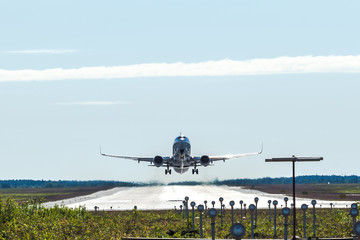 Big passenger airplane taking off and flying from an airport.
