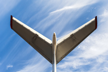 Tail of aircraft. White tail of aircraft on blue sky background.