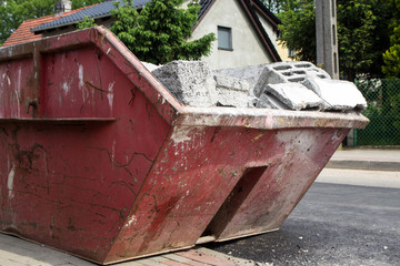red container filled with debris after the building demolition - Demolition container background