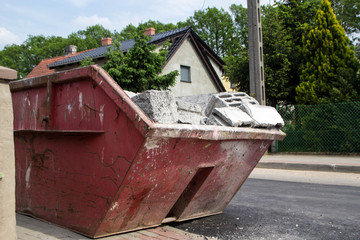 red container filled with debris after the building demolition - Demolition container background