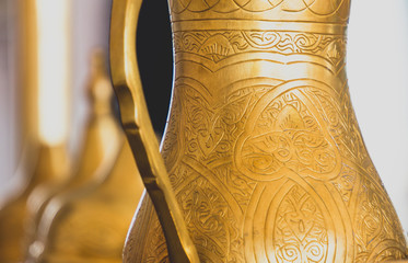 Close-up of golden arabic brass coffee pot.