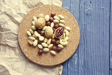Nuts decorated in a plate on a wooden desk