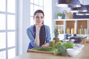 Young with with basket of fresh vegetables in the kitchen