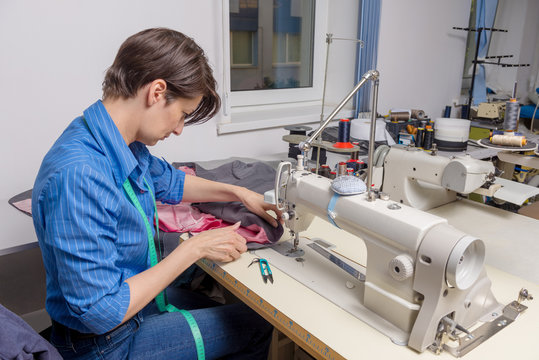 Female tailor at working process. Small business concept.