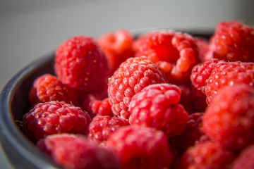 Beautiful, freshly picked garden raspberries in the summer. Summer berries, natural food, healthy dessert.