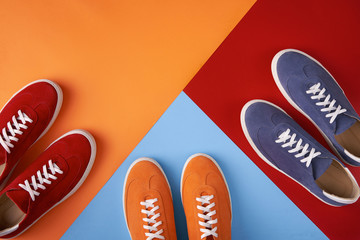 Colorful casual unisex suede trainers standing on multicolored background