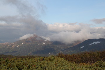 The top of the volcano in Kamchatka is shrouded in vapors, a beautiful mountain landscape.