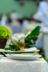 Wedding party dinner table setting with tableware and silverware and glasses set and Candlestick and flower in restaurant.