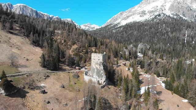 A landscape of the hills and small tourist buildings surrounded forest and mountains - Dolomites, Italy