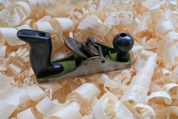 Carpentry tools for wood processing, shavings on a wooden table.