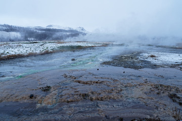 Geothermal lake (hot spring pool) with smoke in Iceland at geysir Strokkur, golden circle