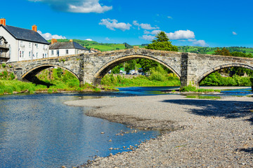 Bridge in Llanwrst, North Wales, United kingdom, view of the buildings overlooking river Conwy, selective focus