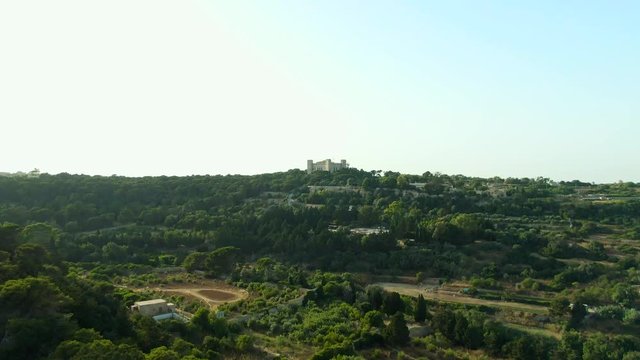 Revealing aerial video of the fields of Buskette approaching the Palace of Verdala, Malta.