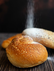 Sweet buns, which are sprinkled with powdered sugar. Close-up. Selective focus. Vertical. Space for text