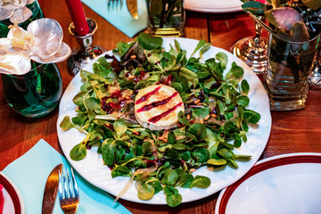 Fresh salad with smoked chicken. Fresh vegetables, herbs, olives, sauce and salad dressing at the counter.  Details close-up and soft focus. Vegetarian food and snacks. 