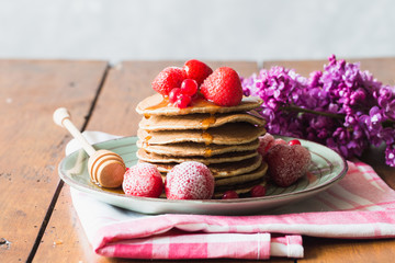 Delicious pancakes with strawberry on brown wooden background
