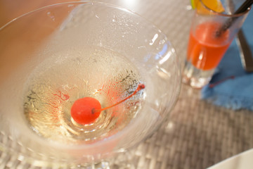 Fototapeta na wymiar red cherry in Cocktail martini glass, close up shot