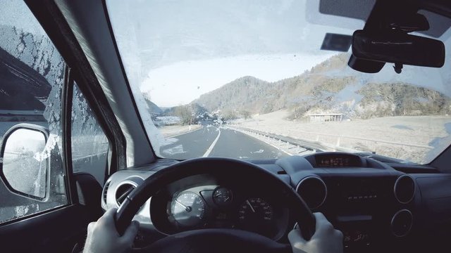 POV of person driving car with frozen windshield 4K