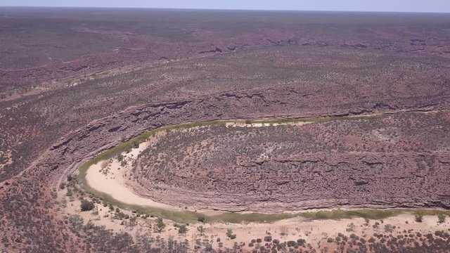 Drone flies over the barren landscape in Klabarri National Park. the canyons and rugged rocks shine in the red desert sun