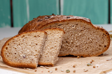 Homemade Black bread. Bread of rye dough on a craft paper. Rye bread for dinner. Fresh fragrant delicious homemade pastries.