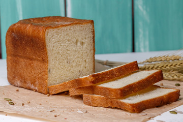 Homemade Black bread. Bread of rye dough on a craft paper. Rye bread for dinner. Fresh fragrant delicious homemade pastries.