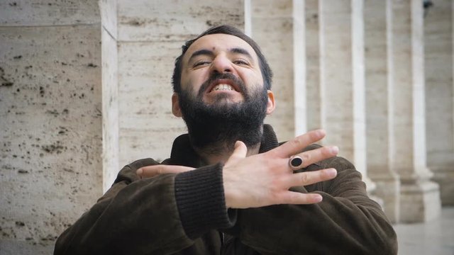  attractive man miming the gesture of strangulation on himself-slow  motion