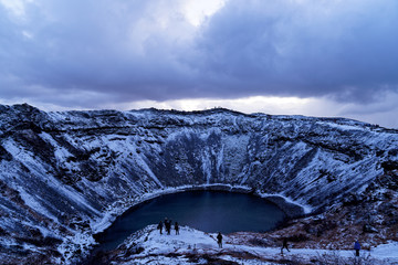 Kerid - Kerið - Crater lake with tourists in Iceland golden circle during winter in december at...