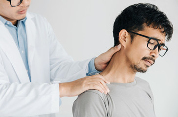 Physiotherapist doing healing treatment on man's neck,Chiropractic adjustment, pain relief...