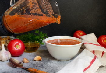 Traditional summer cold tomato soup gazpacho. Tomatoes, garlic, basil, olive oil. The soup is...