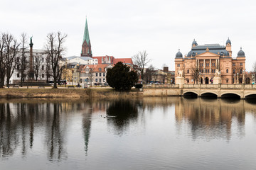 Schwerin, Germany. Views of the buildings of the Old Town reflected in the Schweriner See lake at dusk