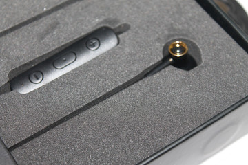 bluetooth headphones in hand on white background close on top