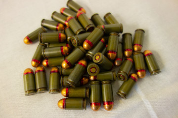Cartridges bulk close up images. Bullets in shells for gun are piled randomly. Weapon armory concept