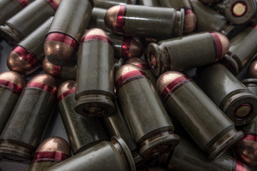 Cartridges bulk close up images. Bullets in shells for gun are piled randomly. Weapon armory concept